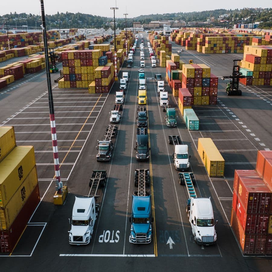 Freight trucks and cargo containers arranged for dispatch